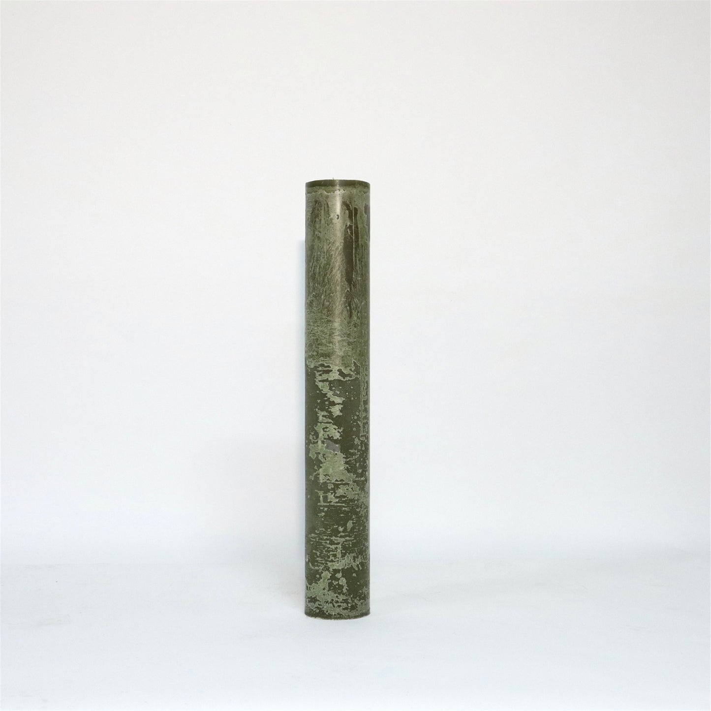 A tall, cylindrical, green candle with a textured surface standing upright against a plain white background.