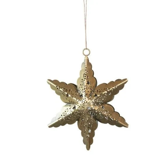 A decorative gold metal star ornament with intricate cut-out patterns, hanging by a thin string, perfect for holiday decor.